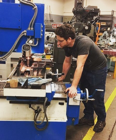 Chris Lemley in the machine shop on campus